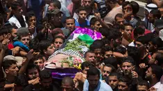 Ribuan pelayat membawa jasad perawat Palestina, Razan Najjar saat pemakamannya di Kota Khan Younis, Jalur Gaza Selatan, Sabtu (2/6). Gadis 21 tahun tersebut terbunuh oleh tembakan Israel pada Jumat, 1 Juni 2018. (AP Photo/Khalil Hamra)