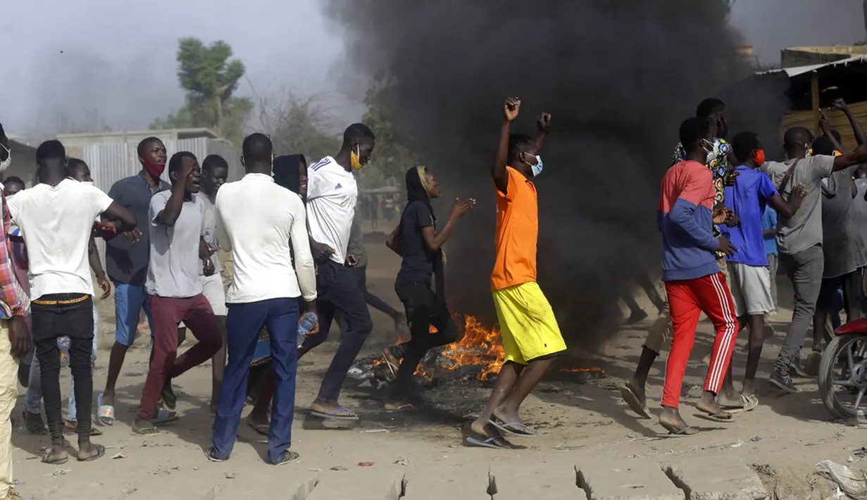 Orang-orang melakukan protes di N'Djamena, Chad, Selasa (27/4/2021). Ribuan orang melakukan protes dan dua orang tewas dalam demonstrasi menentang aturan dewan militer transisi yang dipimpin putra Presiden Idriss Deby Itno yang terbunuh minggu lalu. (AP Photo/Sunday Alamba)