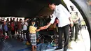 Presiden Joko Widodo memberikan bantuan kepada seorang anak di Lapangan Desa Sumberwuluh, Kabupaten Lumajang pukul 10.21 WIB, Selasa, 7 Desember 2021. (Foto: Laily Rachev - Biro Pers Sekretariat Presiden)