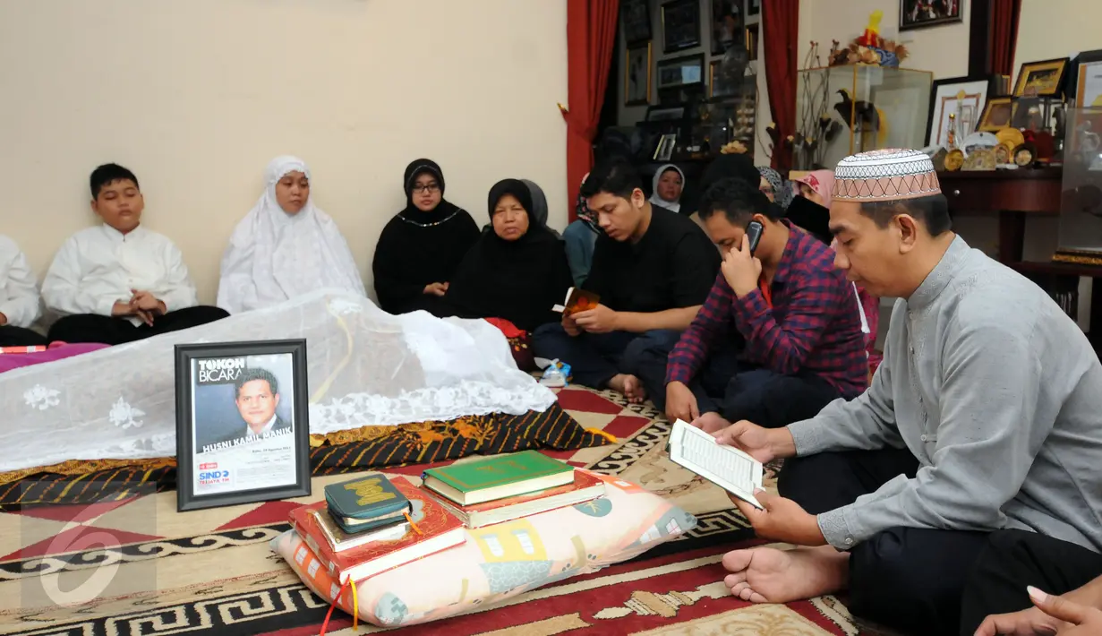 Pelayat membaca Al Quran disisi jenazah Ketua KPU, Husni Kamil Manik di kompleks KPU, Jakarta, Jumat (8/7). Husni Kamil Manik wafat pada Kamis (7/7) di usia 40 tahun. (Liputan6.com/Helmi Fithriansyah)
