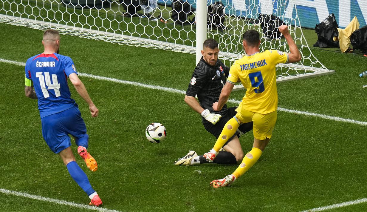 Striker Timnas Ukraina, Roman Yaremchuk (kanan) melepaskan tendangan yang tak mampu dijangkau kiper Timnas Slovakia, Martin Dubravka pada laga matchday kedua Grup E Euro 2024 di Merkur Spiel-Arena, Dusseldorf, Jerman, Jumat (21/6/2024). (AP Photo/Alessandra Tarantino)