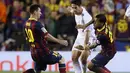 Dua pemain Barcelona, Lionel Messi (kiri) dan Dani Alves berusaha menahan laju serangan Real Madrid yang dibangun dari kaki Isco saat kedua tim berlaga di laga final Piala Raja, di stadion Mestalla, Valencia (17/4/2014). (AFP PHOTO/CESAR MANSO)