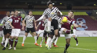 Penyerang Manchester United, Edinson Cavani berebut bola saat menghadapi Burnley dalam partai tunda Liga Inggris 2020/21 di Turf Moor, Rabu (13/1/2021) dini hari WIB. Manchester United sukses mengalahkan Burnley dengan skor tipis 1-0. (Clive Brunskill/Pool via AP)