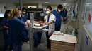 Seorang dokter (kedua kanan) berbicara dengan perawat tentang pasien Covid-19 di unit perawatan intensif rumah sakit Timone, di Marseille, Rabu (5/1/2022). Prancis mencatat rekor kasus baru Covid-19 dalam sehari pada Rabu waktu setempat dengan 335.000 tambahan kasus baru infeksi. (Nicolas TUCAT/AFP)