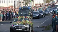Ratusan warga melemparkan bunga saat iringan mobil membawa jenazah Presiden Uzbekistan Islam Karimov di Tashkent, Uzbekistan, Sabtu (3/9). (REUTERS/Muhammadsharif Mamatkulov)