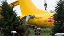 Petugas melakukan evakuasi pada pesawat kargo DHL yang tergelincir di landasan pacu di bandara Orio al Serio, Milan, Italia (5/8). Beruntung insiden ini tidak memakan korban jiwa, namun pesawat mengalami kerusakan parah. (REUTERS)