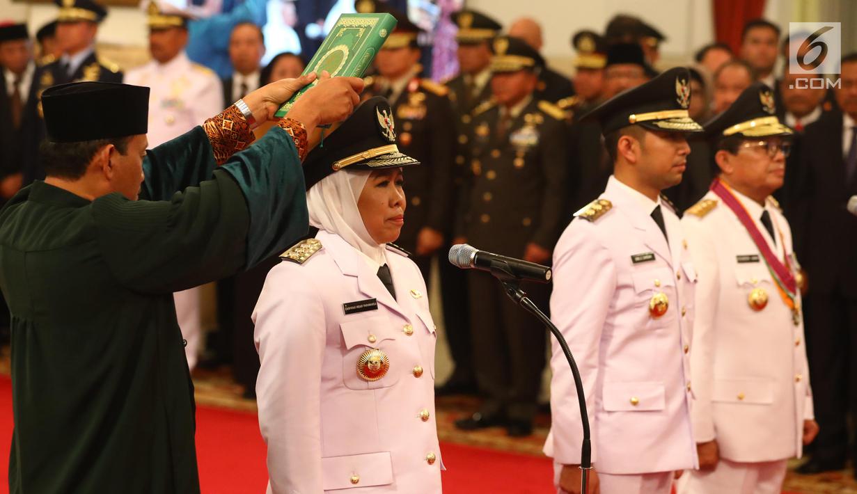 Gubernur dan Wakil Gubernur Jawa Timur Khofifah Indar Parawansa dan Emil Elestianto Dardak bersama Gubernur Jambi definitif, Fachrori Umar saat disumpah jabatan selama pelantikan di Istana Negara, Jakarta, Rabu (13/2). (Liputan6.com/Angga Yuniar)