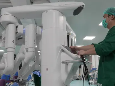 Petugas medis mengoperasikan teknologi robotik saat operasi reseksi hati di Rumah Sakit Umum Pusat (RSUP) Nasional Dr. Cipto Mangunkusumo (RSCM), Jakarta, Kamis (24/10/2024). (Liputan6.com/Herman Zakharia)