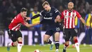 Pemain West Ham Jarrod Bowen (tengah) berebut bola dengan pemain Southampton Romain Perraud (kiri) dan Nathan Redmond pada pertandingan sepak bola putaran kelima Piala FA di Stadion St Mary, Southampton, Inggris, 2 Maret 2022. Southampton menang 3-1. (Adam Davy/PA via AP)