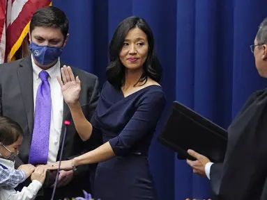 Michelle Wu mengangkat tangannya ketika mengambil sumpah jabatan sebagai Wali Kota Boston, di Balai Kota Boston, Selasa (16/11/2021). Michelle Wu dilantik sebagai perempuan pertama yang menjabat sebagai Wali Kota Boston. (AP Photo/Charles Krupa)