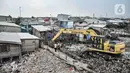 Pekerja Suku Dinas Lingkungan Hidup Kepulauan Seribu menggunakan alat berat saat membersihkan sampah di kawasan Kali Baru, Cilincing, Jakarta Utara, Rabu (23/2/2022). Pembersihan dilakukan menyusul menumpuknya sampah di kampung tempat nelayan bermukim tersebut. (merdeka.com/Iqbal S. Nugroho)