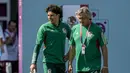 Kiper Meksiko, Guillermo Ochoa (kiri) dan asisten pelatih Norberto Scoponi berbicara selama latihan tim di Jor, Qatar, Selasa, 29 November 2022. Saat ini, baik Arab Saudi maupun Meksiko masih memiliki peluang untuk lolos ke babak 16 besar. Kedua tim harus saling mengalahkan untuk mengamankan laju mereka di Piala Dunia 2022. (AP Photo/Moises Castillo)