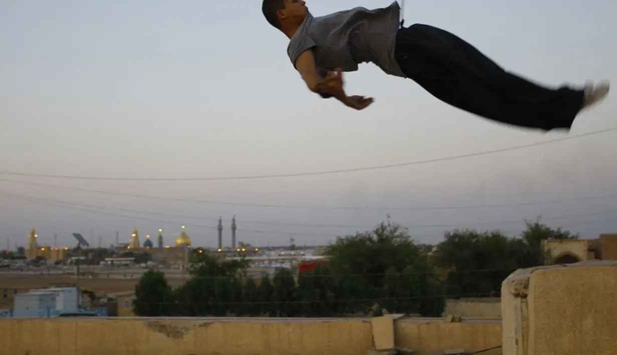 Seorang Traceur (sebutan untuk penggiat Parkour) sedang melakukan aksi Parkour berupa terjun bebas, Irak, Rabu (14/05/2014) (AFP PHOTO/HAIDER HAMDANI).