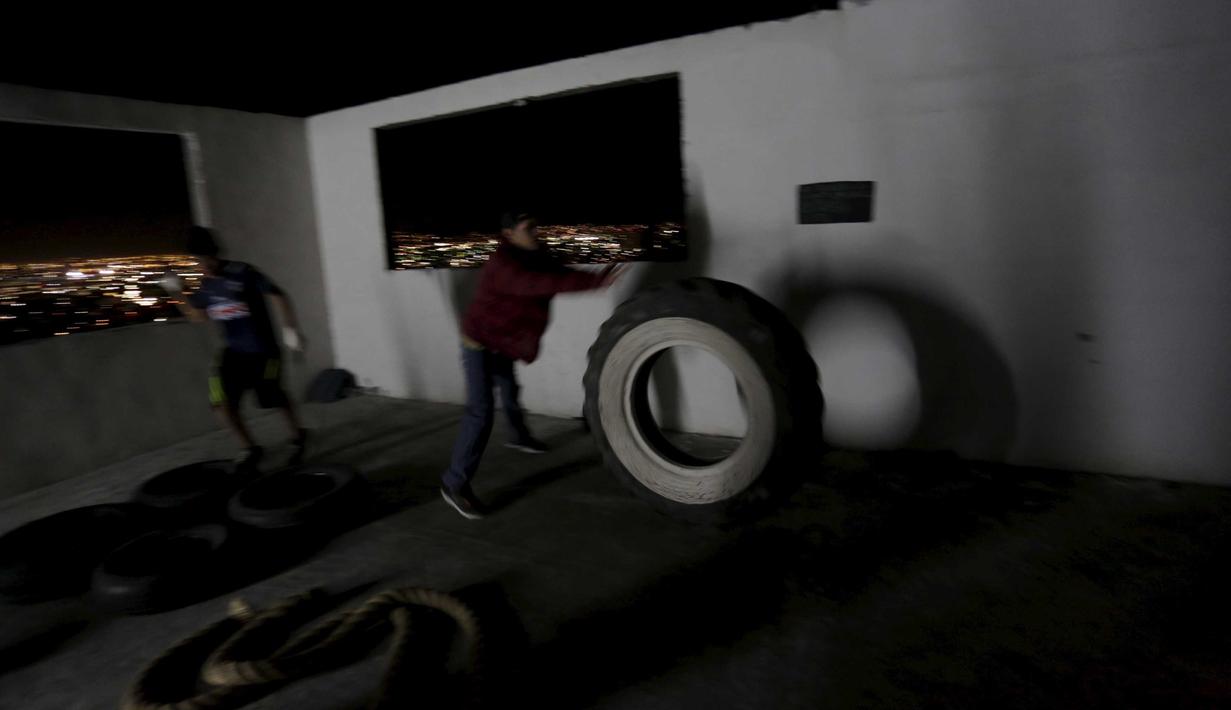 Warga merapikan ruang atap Apartemen sebelum berlatih tinju yang bertujuan untuk kegiatan sosial serta peningkatan taraf hidup warga setempat di Monterrey, Mexico (29/1/2016). (REUTERS/Daniel Becerril) 