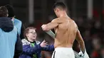 Penyerang Portugal Cristiano Ronaldo memberikan jerseynya untuk seorang fans cilik Irlandia yang berjalan ke lapangan pada akhir laga Grup A Kualifikasi Piala Dunia 2022 Zona Eropa di Stadion Aviva, Jumat (12/11/2021) dinihari WIB. Portugal ditahan imbang Irlandia 0-0. (AP /Peter Morrison)