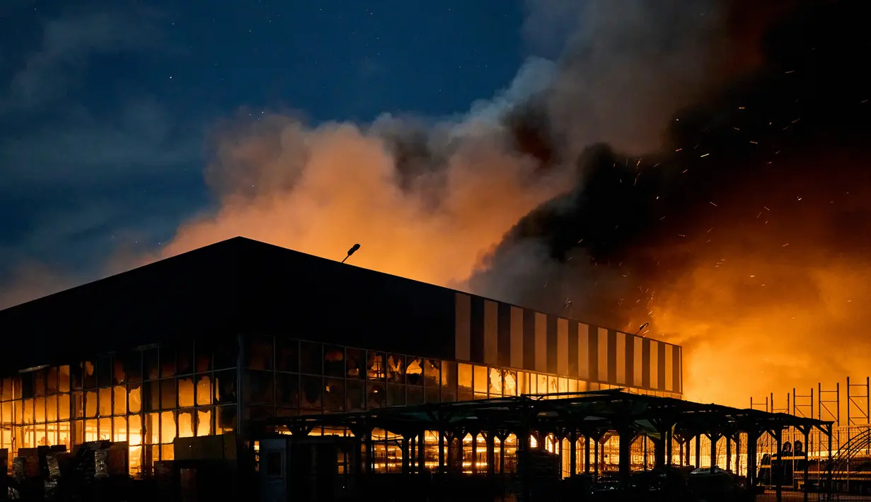 Asap membumbung setelah penembakan Rusia menghantam sebuah pusat perbelanjaan di Kherson, Ukraina, 3 Februari 2023. Asap membumbung tinggi dari pusat perbelanjaan yang terbakar setelah serangan Rusia ke pusat perbelanjaan tersebut. (AP Photo/LIBKOS)