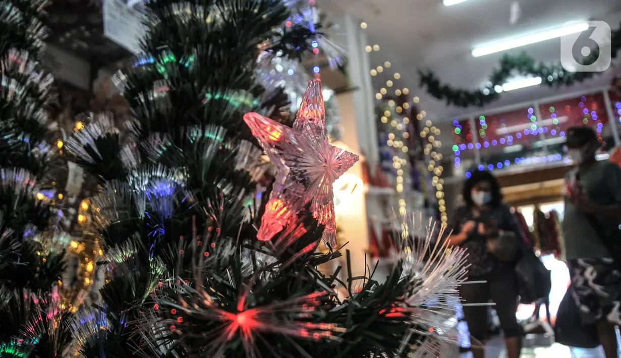 Pengunjung saat melihat pernak-pernik Natal di salah satu toko di Pasar Asemka, Jakarta, Kamis (9/12/2021). Menurut salah satu pedagang, warga khususnya umat Kristiani mulai ramai berburu pernak-pernik Natal dan Tahun Baru sejak pertengahan November lalu. (merdeka.com/Iqbal S Nugroho)