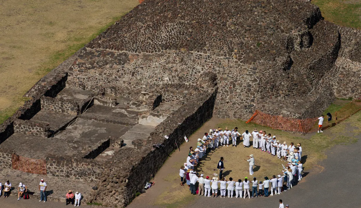 Wisatawan melakukan ritual upacara menyambut fenomena equinox di depan Piramida Matahari, Teotihuacan, Meksiko, Senin (20/3). Sampai hari ini perayaan equinox dianggap sebagai tradisi sakral oleh penduduk Meksiko. (AP/Rebecca Blackwell)