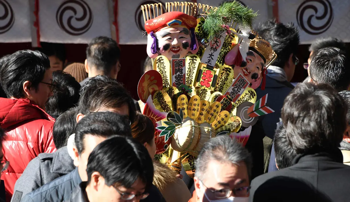 Sebuah "kumade" (tengah), sebuah rake yang terbuat dari bambu yang digunakan untuk mengumpulkan keberuntungan dan uang terlihat selama upacara awal tahun di Kuil Kanda Myojin, Tokyo (4/1). (AFP Photo/Toshifumi Kitamura)