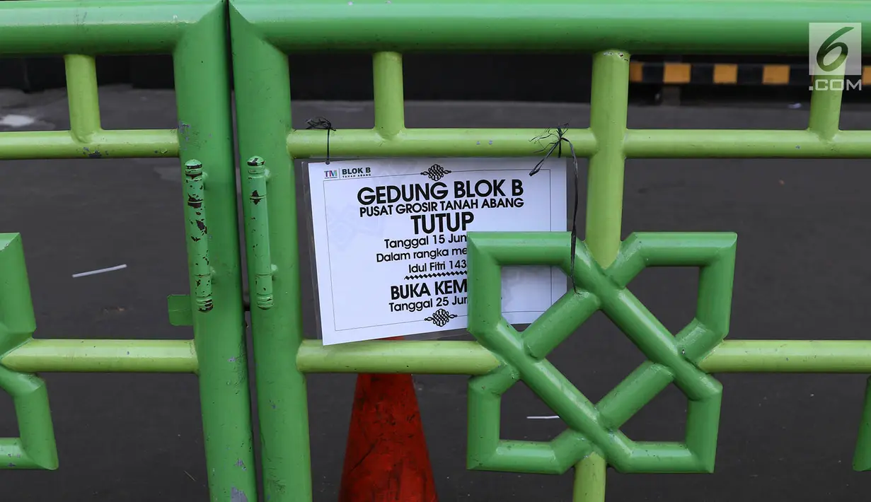 Pengumuman ditutupnya Pasar Tanah Abang, Jakarta, Jumat (22/6). Sebagian pedagang terpaksa menggelar lapak di luar gedung akibat belum dibukanya kembali Pasar Tanah Abang usai Lebaran. (Liputan6.com/Immanuel Antonius)