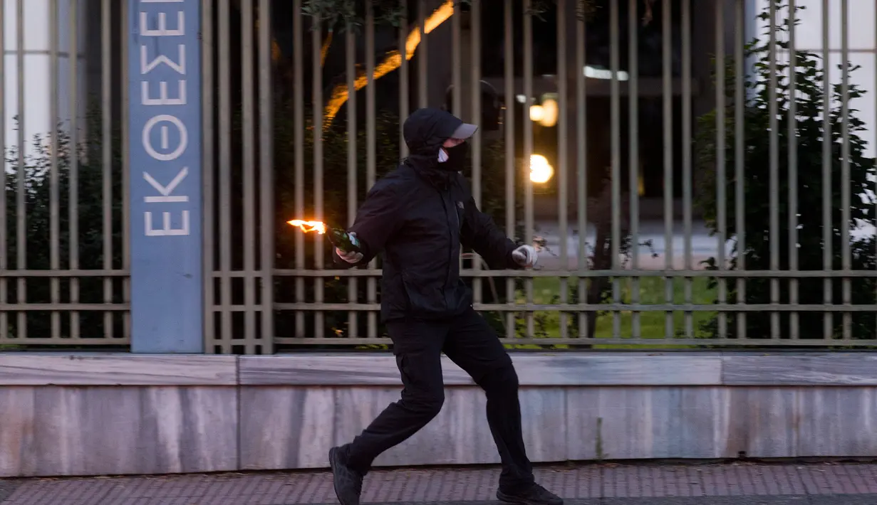Pengunjuk rasa bersiap melemparkan bom molotov ke arah polisi antihuru-hara saat unjuk rasa terkait kematian warga Afrika-Amerika yang bernama George Floyd di Athena, 3 Juni 2020. Ribuan orang ambil bagian dalam unjuk rasa di ibu kota Yunani pada Rabu (3/6) atas kematian Floyd. (Xinhua/Marios Lolos)