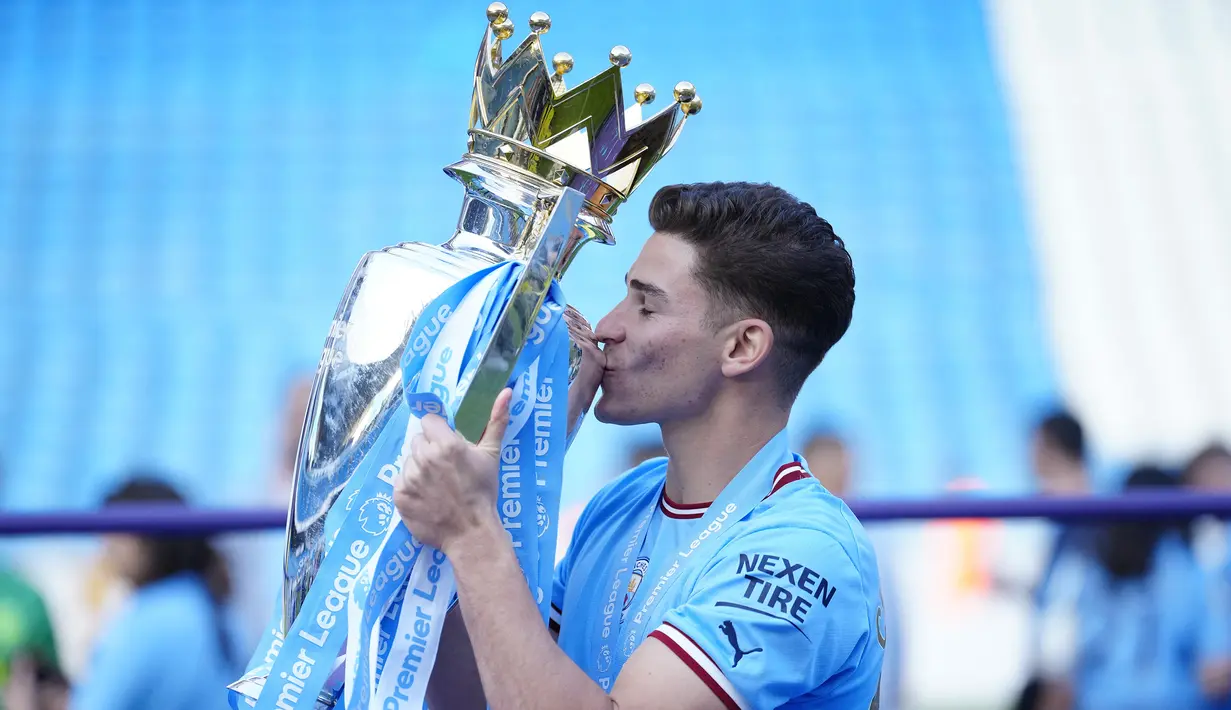 Striker Manchester City, Julian Alvarez berpose dengan mencium trofi Liga Inggris saat perayaan gelar usai laga pekan ke-37 menghadapi Chelsea di Etihad Stadium, Manchester (21/5/2023). Julian Alvarez didatangkan pada awal musim 2022/2023 dari River Plate. Sejauh ini ia telah tampil 29 kali di Liga Inggris, termasuk di laga terakhir saat menang 1-0 atas Chelsea, dengan torehan 9 gol dan 1 assist. (AP Photo/Jon Super)