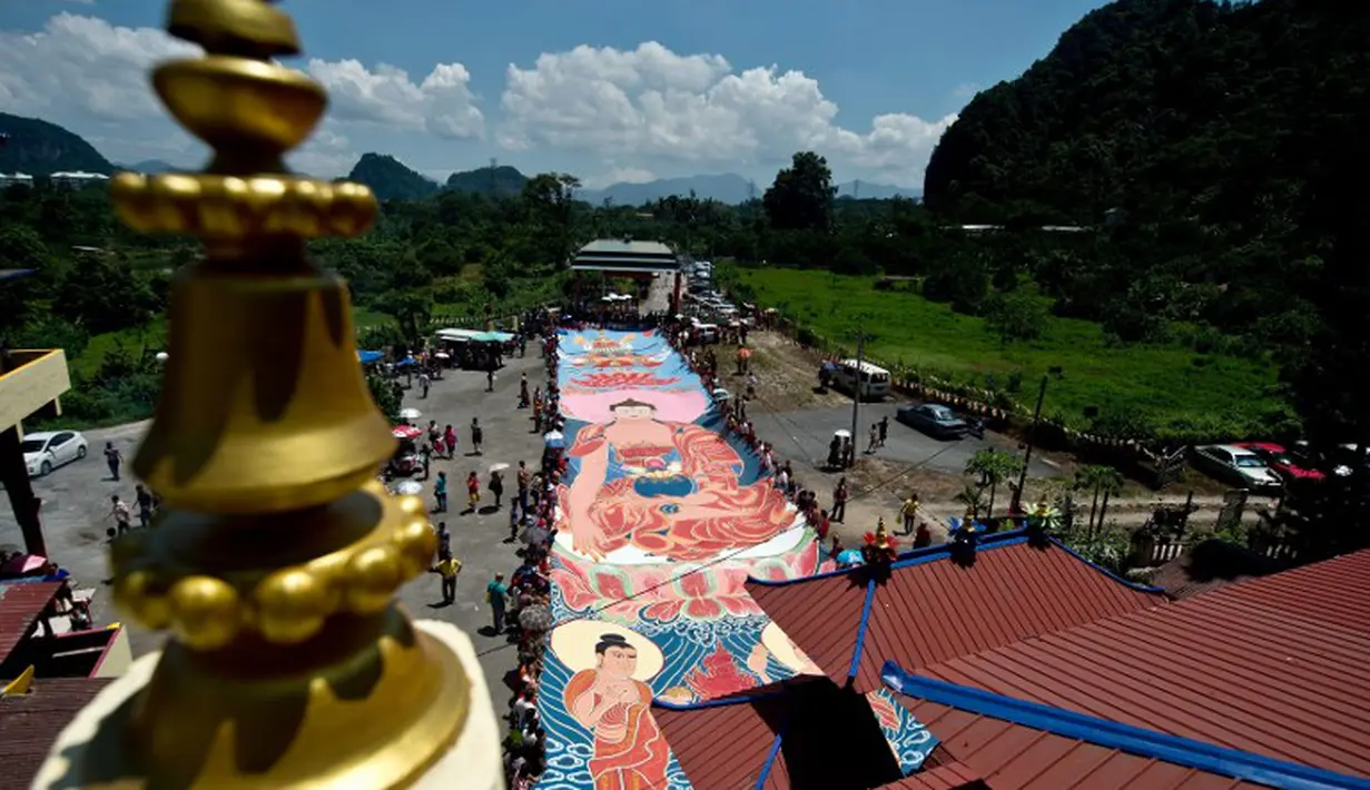 Ratusan umat berduyun-duyun untuk mengambil bagian dalam 'ritual sunning Buddha' bagian dari perayaan Waisak, Myanmar, Selasa (13/05/2014) (AFP Photo/Manan Vatsyayana)
