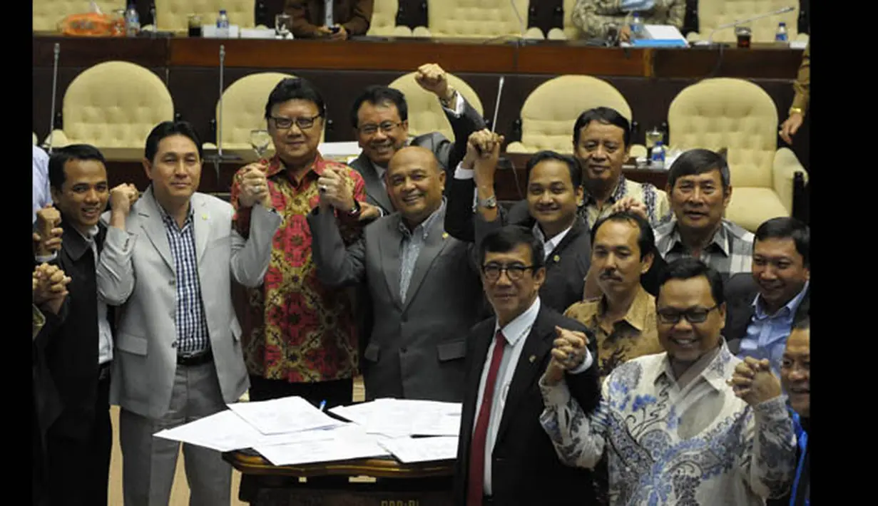 Mendagri Tjahjo Kumolo, Menkumham Yasonna Laoly bersama anggota Komisi II DPR RI melakukan salam komando usai penandatangan Perppu Pilkada, Jakarta, Senin (19/1/2015). (Liputan6.com/Andrian M Tunay)