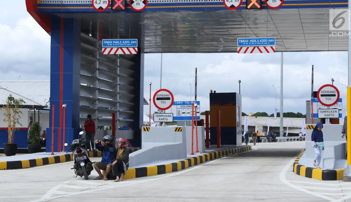 Warga berswafoto berlatar gerbang tol Cigombong I di Cigombong, Kab Bogor, Jawa Barat, usai diresmikan, Sabtu (1/12). Ruas panjang tol Ciawi-Sukabumi Seksi I Ciawi-Cigombong sejauh 15,3 kilometer. (Liputan6.com/Helmi Fithriansyah)