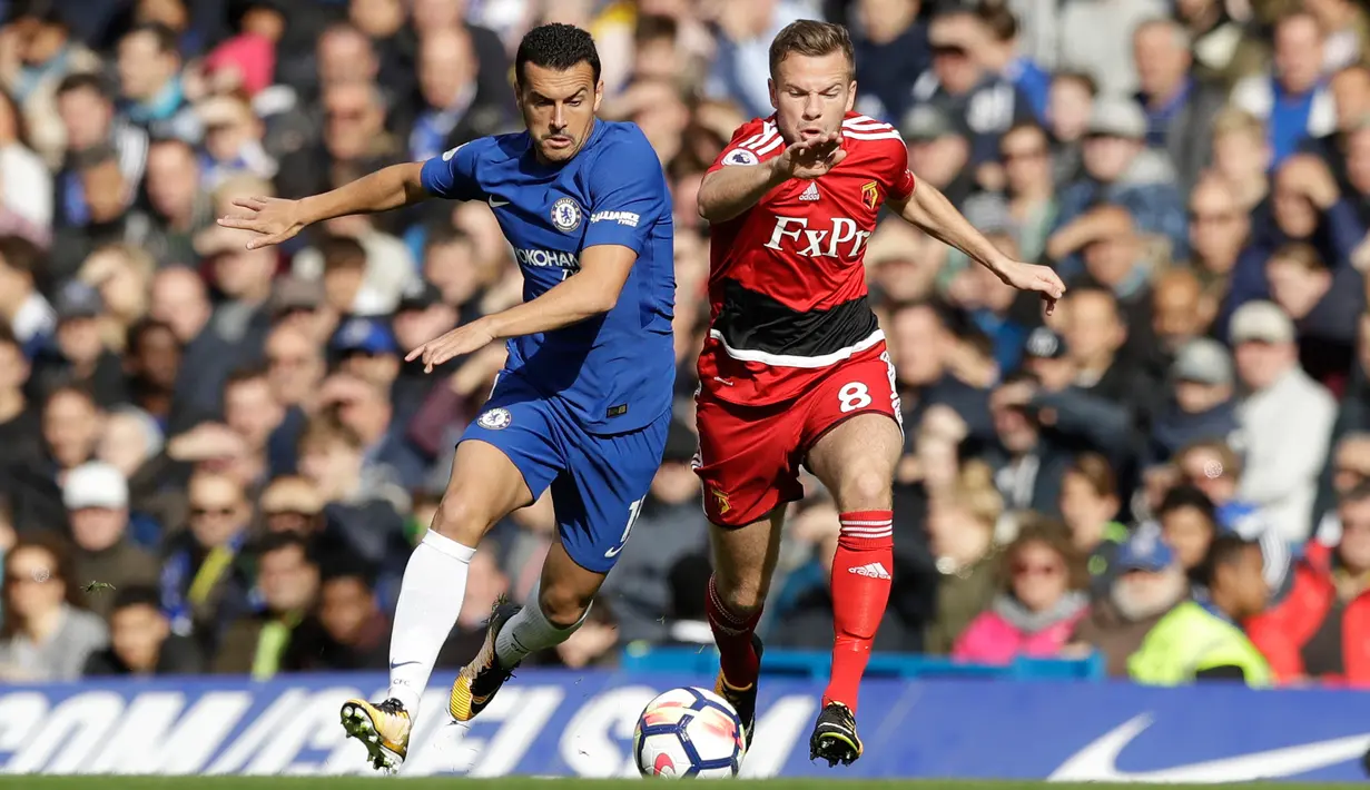 Pemain Chelsea, Pedro (kiri) berebut bola dengan pemain Watford Tom Cleverley saat pertandingan Liga Inggris di stadion Stamford Bridge di London (21/10). (AP/Matt Dunham)