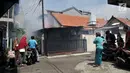 Warga menyaksikan petugas melakukan penyemprotan asap (fogging) nyamuk demam berdarah dengue (DBD) di RW 01, Kelurahan Cipinang, Jakarta, Minggu (10/3).   Fogging ini juga untuk membasmi perkembangbiakan jentik nyamuk. (merdeka.com/Iqbal Nugroho)