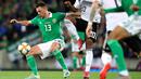 Gelandang Irlandia Utara, Corry Evans (kiri) menahan gelandang Jerman, Serge Gnabry (kanan) selama pertandingan kualifikasi Euro 2020 di Windsor Park, Belfast, Senin (9/9/2019). Jerman berhasil merebut puncak klasemen grup C kualifikasi Euro 2020 usai mengalahkan Irlandia Utara 2-0. (Paul Faith/AFP)