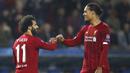Penyerang Liverpool, Mohamed Salah bersama Virgil van Dijk merayakan gol ke gawang KRC Genk pada laga Liga Champions 2019 di KRC Genk Arena, Rabu (23/10). Liverpool menang 4-1 atas KRC Genk. (AP/Francisco Seco)