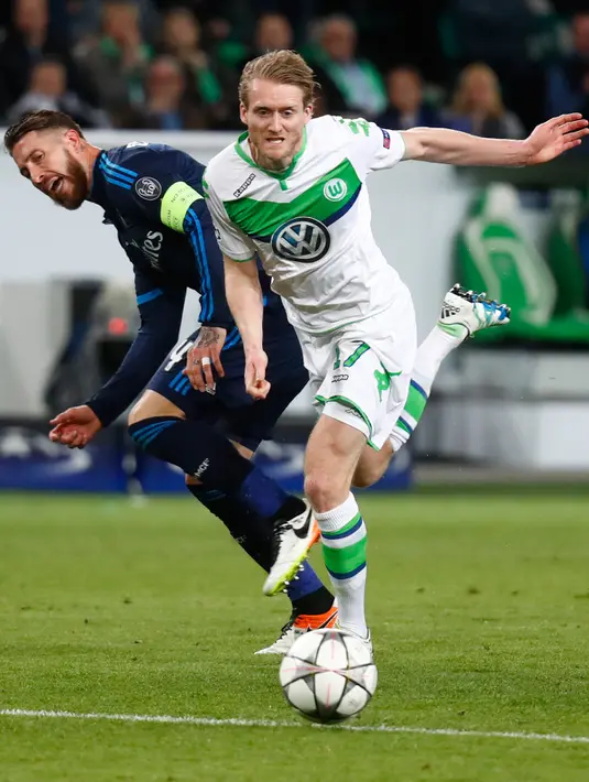 Penyerang Wolfsburg, Andre Schurrle (kanan) berusaha melewati bek Real Madrid, Sergio Ramos pada leg pertama liga champions di Stadion Volkswagen Arena, Wolfsburg, Jerman (7/4). Madrid takluk atas Wolfsburg dengan skor 2-0. (Reuters/Kai Pfaffenbach)
