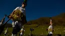 Sekelompok Joaldunaks atau biasa disebut Zanpantzar saat mengikuti karnaval di antara desa Pyrenees Ituren dan Zubieta, Spanyol (29/1). Para peserta ini membawa lonceng yang menggantung di punggung bawah mereka. (AP Photo / Alvaro Barrientos)