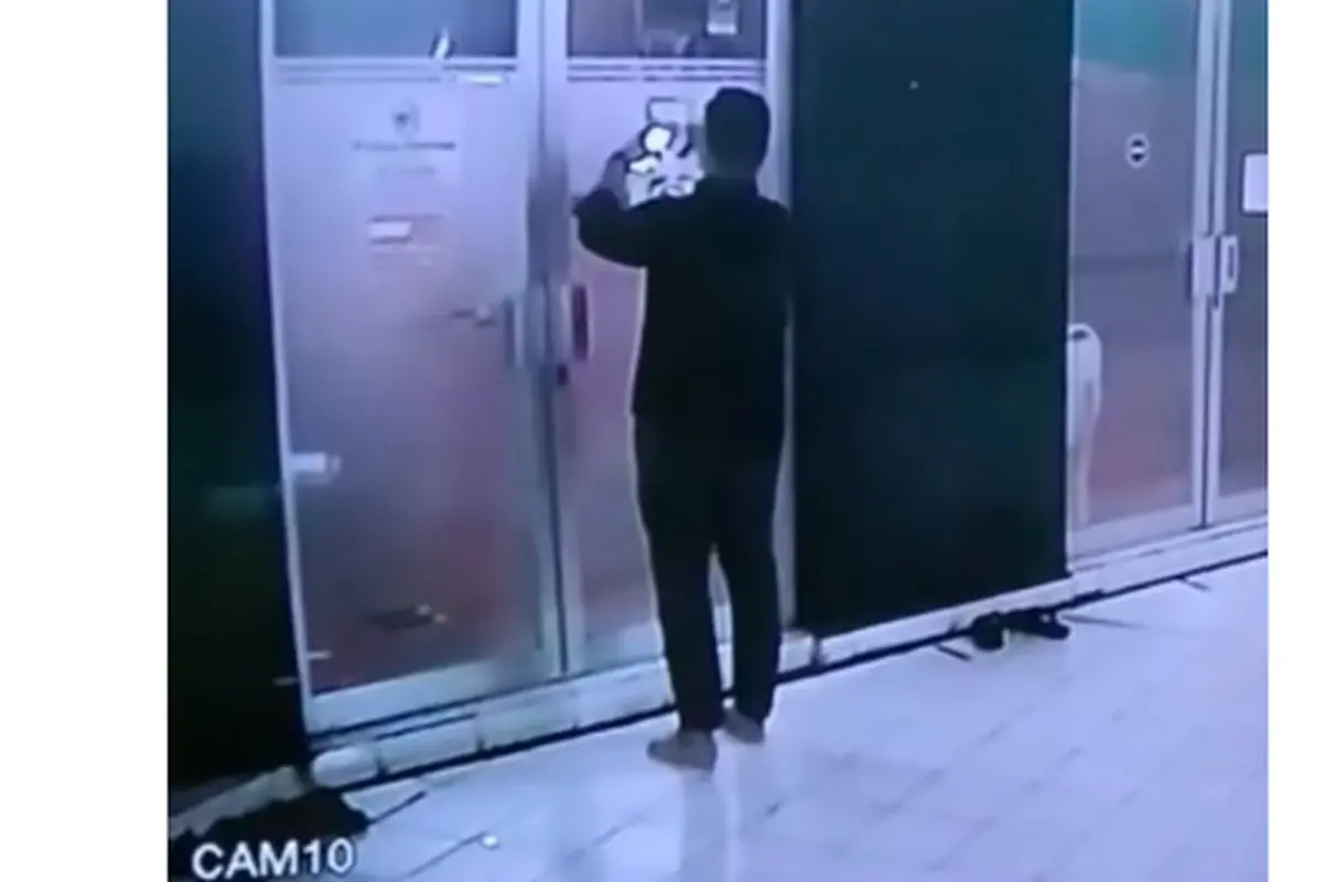 Seorang pria berbadan gempal tersorot rekaman CCTV diduga sedang memalsukan tampilan QRIS/ QR Code Masjid