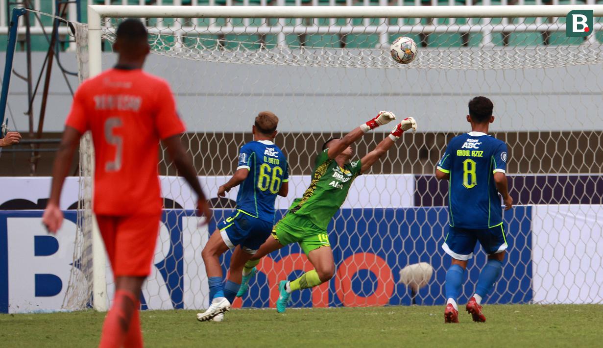 Penjaga gawang Persib Bandung, Teja Paku Alam (tengah) berusaha menghalau bola dalam pertandingan lanjutan BRI Liga 1 2022/2023 melawan Borneo FC yang berlangsung di Stadion Pakansari, Bogor, Kamis (26/1/2023). (Bola.com/Ikhwan Yanuar)