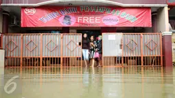 Sejumlah warga melihat banjir di halaman rumahnya di perumahan Pondok Hijau Permai, Bekasi, Senin (20/2). Banjir yang melanda disebabkan mengecilnya saluran air kali yang berujung di wilayah Jatimulya. (Liputan6.com/Gempur M. Surya)