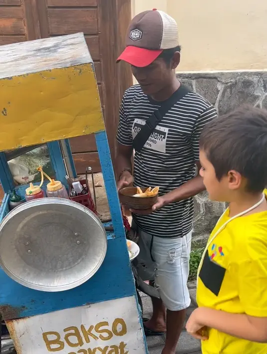 Momen El Barack yang berparas bule dan komunikasi menggunakan bahasa Inggris jajan bakso. Bukan bakso ditempat yang mewah, melainkan bakso keliling menggunakan gerobak. [Instagram/inijedar]