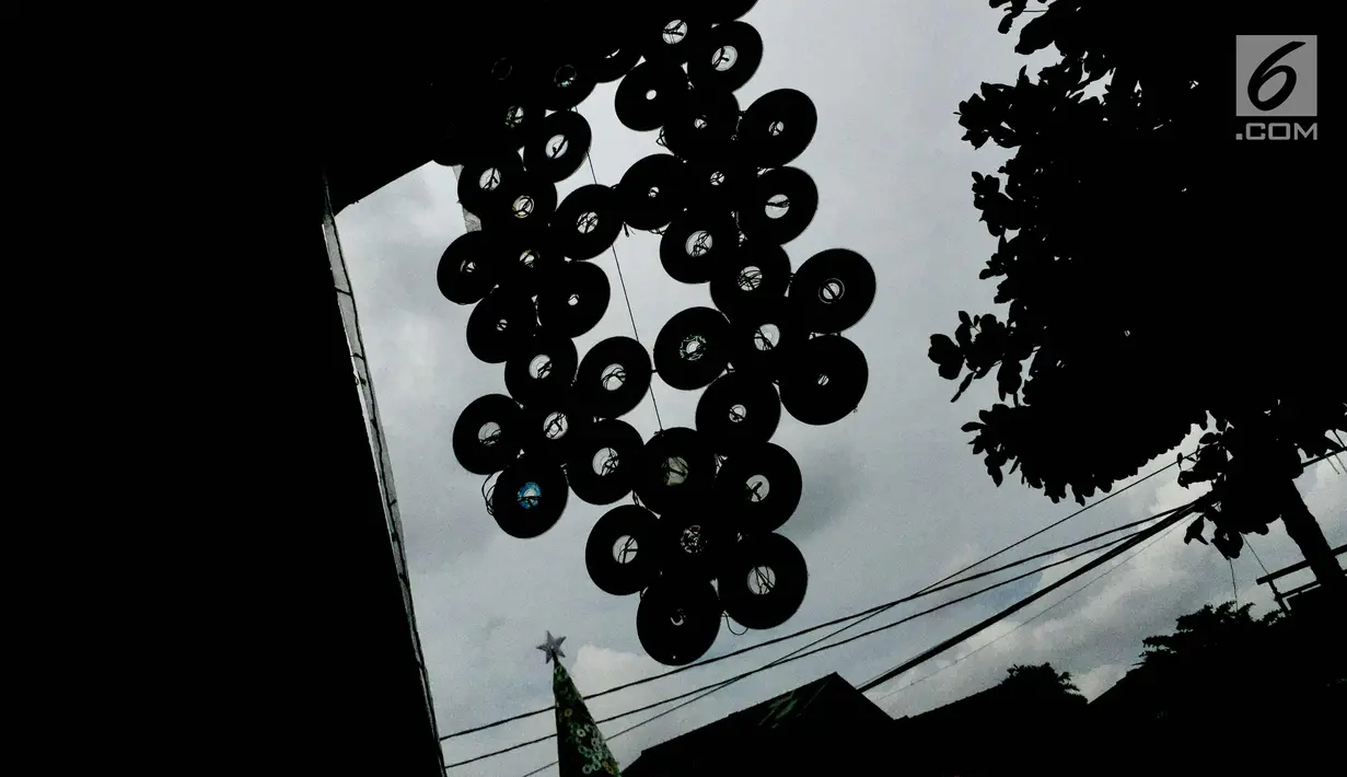 Kepingan CD terlihat di depan Gereja Kristen Pasundan Jemaat Depok, Jawa Barat, Selasa (19/12). Pohon Natal setinggi 5,5 meter terbuat dari 1.100 keping CD bekas dan 4.400 hiasan lampu. (Liputan6.com/Immanuel Antonius)