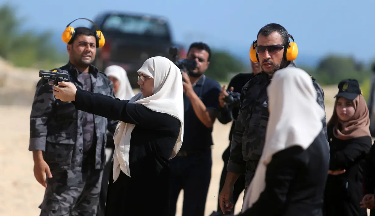 Sejumlah wanita Palestina mengikuti latihan menembak di Khan Younis di Jalur Gaza, Minggu (24/7). ). Pelatihan menembak tersebut dilatih langsung oleh anggota Perlindungan dan Keamanan Hamas. (REUTERS/ Ibraheem Abu Mustafa)