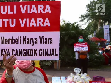 Seorang warga melakukan Aksi Peduli Viara untuk biaya cuci darah dan cangkok ginjal di kawasan Bundaran HI, Jakarta, Minggu (10/09). Aksi dengan menjual buku dan boneka kesayangan untuk biaya pengobatan. (Liputan6.com/Fery Pradolo)
