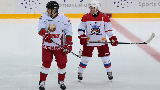 Presiden Rusia Vladimir Putin (kanan) dan Presiden Belarus Alexander Lukashenko (kiri) ikut serta dalam pertandingan hoki es di Shayba Arena, Resor Laut Hitam Sochi, Rusia, (15/2). (Sergei Chirikov / Pool / AFP)