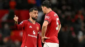 Gelandang Manchester United asal Portugal #08, Bruno Fernandes, berbicara dengan bek Manchester United asal Inggris #05, Harry Maguire (kanan), dalam pertandingan&nbsp;Premier League antara Manchester United dan Chelsea di Old Trafford, Manchester, Inggris barat laut, pada 20 September 2025. (Oli SCARFF/AFP)