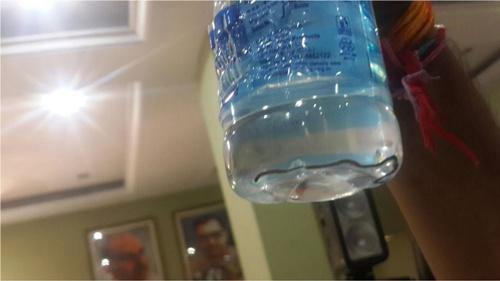 Botol minuman yang dengan anak ular di dasarnya | Photo: Copyright bbc.com