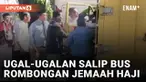 Aksi sebuah mobil box ugal-ugalan saat di jalan hendak menyalip bus rombongan jemaah haji mengundang perhatian