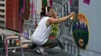 Seniman grafiti Sandra Fabara atau lebih dikenal Lady Pink melukis mural di Casita Maria, Bronx, New York, AS, Minggu (2/6/2019). Lady Pink dikenal juga dengan julukan 'The First Lady of Graffiti' atau 'Ibu Negara Grafiti'. (Don Emmert/AFP)