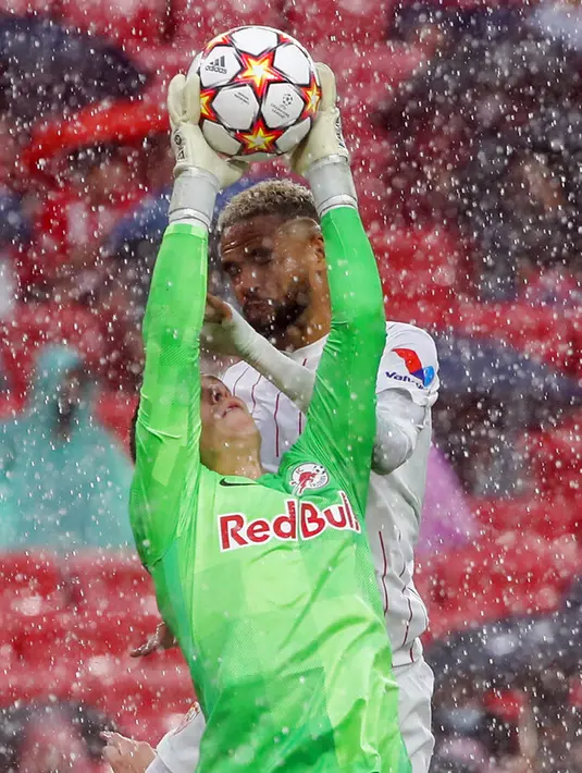 Penjaga gawang Salzburg Philipp Koehn (depan) menyelamatkan bola di sebelah pemain Sevilla Youssef En-Nesyri pada pertandingan Grup G Liga Champions di Stadion Ramon Sanches Pizjuan, Seville, Spanyol, Selasa (14/9/2021). Pertandingan berakhir dengan skor 1-1. (AP Photo/Angel Fernandez)