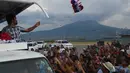 Manny Pacquiao melempar topi ke pendukungnya selama kampanye di kota Calamba, Provinsi Laguna, selatan Manila (28/4). Manny Pacquiao menjadi salah satu politisi Filipina yang paling kuat di negaranya. (AFP PHOTO/TED aljibe)