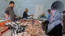 Warga membeli ikan untuk persiapan menyambut datangnya bulan Ramadan di Ibu Kota Tripoli, Libya, 1 Mei 2019. Ramadan kali ini diperkirakan akan terasa berat bagi warga Tripoli karena bayang-bayang krisis dan pertempuran. (MAHMUD TURKIA/AFP)